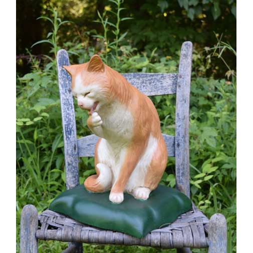 cat statue with waving paw